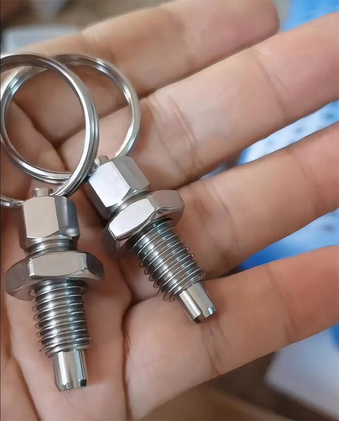 Close-up of two Beefy Heavy Duty Stainless Steel Pull Ring Indexing Plungers in hand, showcasing M10 threads and durable design.