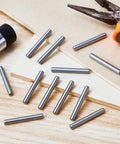 Stainless Steel Shelf Dowel Pins 5mm By 40mm, 32 Pack, Anti Rust Shelf Support Pegs on wooden surface with tools