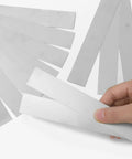 Hand holding Stainless Steel Shim Stock Strips Set 10 Pieces 1 Inch Wide By 6 Inches Long 0.012 Inch Thick Pro Grade 304 Silver Metal