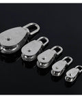 Set of five Stainless Steel Pulley M25 Single Wheel Swivel Lifting Rope Pulley Set Lifting Wheel Tools on black background
