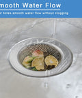 Two Pack Stainless Steel Sink Strainers For Most Kitchen Drain Baskets 4.5 Inch Outer Diameter installed in sink with food debris.