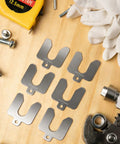 96 Piece Slotted Stainless Steel Shim Kit For Leveling And Precision Fit 2X2 Inch Shims, tools and gloves on wooden surface.
