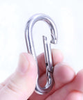 Hand holding 2.4 Inch 304 Stainless Steel Spring Snap Hook Heavy Duty 264 Pound Load Capacity Quick Release Clip