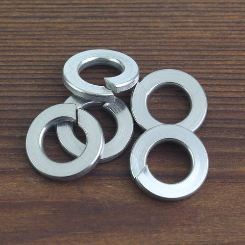 100 Pack Size 10 Stainless Steel Split Lock Washers For Screws And Bolts on wooden surface