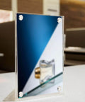 Acrylic frame on table secured with 4 Pack Stainless Steel Sign Standoff Screws With Rubber Gaskets For Glass Displays M6 X 16mm Thread