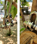 Close-up of Long Unbuckled U Shaped Swivelling Pulley Stainless Steel Duplex Bearing, attached to outdoor setup for lifting.