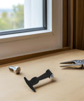 Front view: two-piece adjustable T-handle draw latch set; black plastic latch with metal end and hex bolt