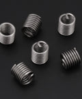 Coiled wire sleeve inserts from Premium SAE Thread Repair Kit With 60 Pcs 304 Stainless Steel for automotive repair.