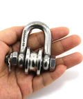 Hand holding silver stainless steel Long Unbuckled U Shaped Swivelling Pulley Duplex Bearing suitable for small cranes and salvage.