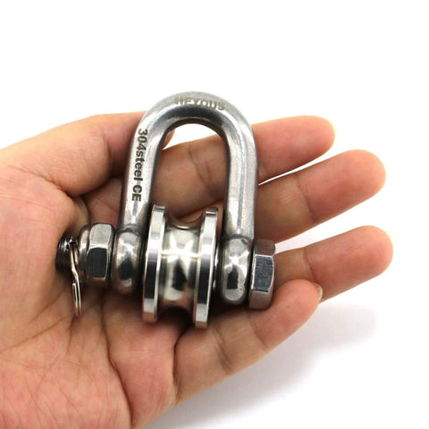 Hand holding silver stainless steel Long Unbuckled U Shaped Swivelling Pulley Duplex Bearing suitable for small cranes and salvage.