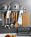 Utensil Hanging Rack Stainless Steel Rail Hanger Rod Wall Mounted Pot Pan Lid Holder Cookware Storage Organizer with Sliding Hooks for Kitchen Bathroom displaying utensils, lids, and a towel on a kitchen wall.