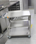 Three Tier Stainless Steel Utility Cart For Restaurant Hospital Lab And Hotel Use With Beefed Up Heavy Duty Wheels And Easy Handle Food Service Trolley 19W x 31L x 34H Treshin, shown in a kitchen setting.