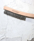Wire Brush, Heavy Duty Stainless Steel Wire Brushes for Cleaning Rust, with 14" Beech Handle shown removing paint from wall surface.