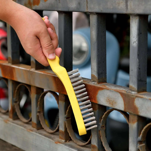 Wire Scratch Brush 2 Set in use, cleaning rust from metal railing; heavy duty stainless steel 11 inch with plastic handle by MAXMAN.