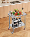Heavy Duty Stainless Steel Work Table With Four Rolling Casters 36 By 24 Inches Commercial Kitchen Food Prep Station For Restaurant Use Easy To Clean Durable Silver with utensils and vegetables on top in a kitchen setting.