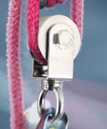 Close-up of 2 Pack V Type Swivel Pulley With 304 Stainless Steel Double Ball Bearing in use with pink rope, corrosion-resistant design
