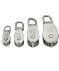 Front view of four stainless steel pulleys of different sizes, including M20 Single Swivel Lifting 0.3" Rope Pulley Roller Block.