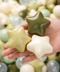 Hand holding green and cream star-shaped Ball Pit Balls 100 for Toddlers - Green Ball Pit Ball Shapes for Boys Girls Fun, Birthday Party, Christmas Decoration, Cream Colors Mix Green