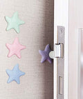 Starfish-shaped silicone bumpers protecting wall from door handle, self-adhesive installation showing in pastel colors