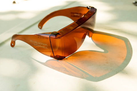 Amber StarShield Fit Over Sunglasses With Lenses And Blue Light Blocking UV Protection on table