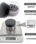 Container of steel balls on scale showing total weight for 200-pack, indicating 0.7g per ball with close-up view.