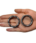 Hand holding Bike Ball Bearing Retainer Set 5/16 Inch Ball Bearings for Bicycle Crank Bottom Bracket Replacement, showing two retainers.
