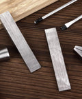 12 Piece Steel Flange Wedges Set, 4 Inch Long, 3/4 Inch Wide, 1/2 Inch Thick, Metal Wedge Shims For Lathes And Welding Machines, shown on table