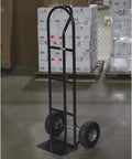 Steel Pneumatic Hand Truck Dolly - 600-Lb. Capacity, 10in. Tires, Powder-Coat Finish standing on warehouse floor.