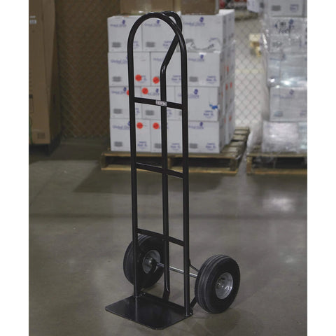 Steel Pneumatic Hand Truck Dolly - 600-Lb. Capacity, 10in. Tires, Powder-Coat Finish standing on warehouse floor.