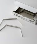 Prong Fastener Bases For Officemate OIC99854 Heavy Duty Steel Two And Three Quarters Inch Center To Center Two Inch Sheet Capacity 100 Per Box Silver Finish Corrosion Resistant shown with box and two fasteners.