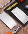 2 Pack Flange Wedge Set 4x2 Inch Beveled Right Angle Steel Wedges on wooden table with tools