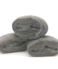Three rolls of coarse steel wool fill fabric for mouse proofing homes displaying texture