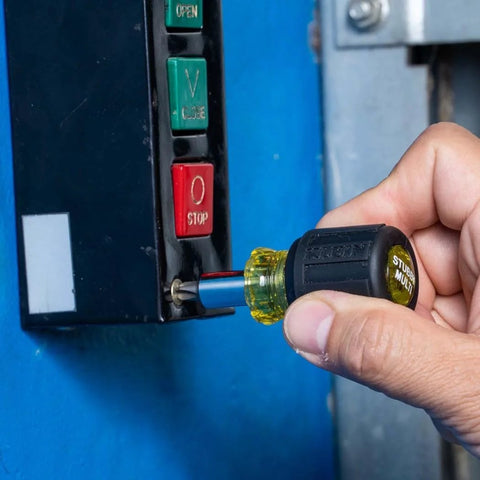 Person using 6-In-1 Stubby Screwdriver And Nut Driver with Interchangeable Shaft on electrical panel