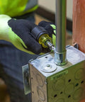 Person using 6-In-1 Stubby Screwdriver And Nut Driver with interchangeable shaft in electrical panel, showing compact design.