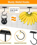 Sturdy metal hooks mounted on white surface holding a 13 lb kettlebell and a bunch of bananas, showcasing load capacity.