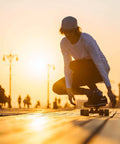 Skater in sunset using 54mm Skateboard Wheel Set with ABEC 9 Bearings Four Pack Cruiser Street Wheels on boardwalk.