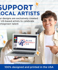 Person holding a laptop displaying Bliss Monkey Co. logo; sign supporting local artists, emphasizing US-based design and printing.