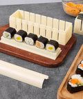 Complete Sushi Making Kit With 3 Shape Molds Rice Roller Tool and Spatula for pro-looking home rolls, showcasing sushi on a board.