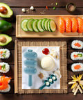 Rice Ball Maker Shake And Mold Kit with sushi ingredients and rice molds on a table, for creating uniform sushi balls at home.