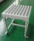 Table with multiple 5/8 Inch Swivel Ball Caster Roller Transfers Set of 6 Hardened Steel Ball Units Screw Mounted visible on surface.