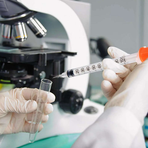 Lab technician using 30 Pack U100 Syringes 1Ml 30G 5 Sixteenth Inch Needles Disposable Individually Wrapped For Precise Liquid Measurement