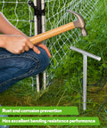 Installing 2 Pack 36 Inch T Handle Galvanized Ground Rod with hammer near electric fence, for industrial power setups and chemical industry use.