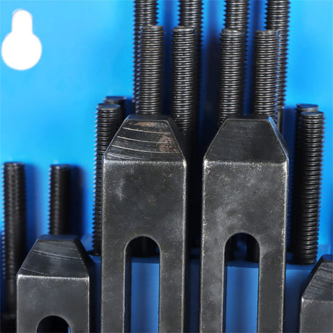 Close-up of T-slot clamping kit for Bridgeport mill showing studs and step blocks for secure milling setup.