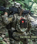 Tactical soldier carrying a backpack with 170 Piece Survival First Aid Kit With Trauma Gear For Hiking Camping And Backpacking