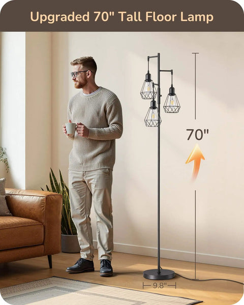 70 Inch Farmhouse Floor Lamp With Diamond Cage Shade And Dimmable Lighting Includes Three LED Edison Bulbs Rustic Tree Corner Accent For Living Room Bedroom Or Office Black Finish Modern Cozy Vibe Lighting next to a man holding a cup.