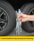 Heavy Duty Tandem Axle RV Wheel Chocks And Tire Stabilizers 2 Pack Keeps Campers Trailers Secure Fits Tires From 2 To 17 Inches Stromberg Carlson being held by a person beside two RV tires