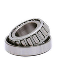 Close-up of Tapered Roller Bearing LM67048 LM67010, Set of 4 showcasing metal construction and roller design for automotive use.