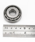 Two Piece 30302 Tapered Roller Bearing Cone And Cup Set 15x42x14.25mm with ruler for scale, chrome steel for cars and machinery