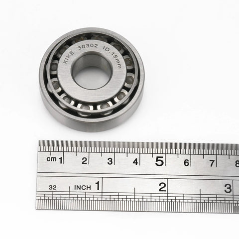 Two Piece 30302 Tapered Roller Bearing Cone And Cup Set 15x42x14.25mm with ruler for scale, chrome steel for cars and machinery