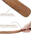 Teak Wood Mattress Lifter And Sheet Tucker Tool For Easier Bed Making, showing smooth surface and ergonomic design in hand